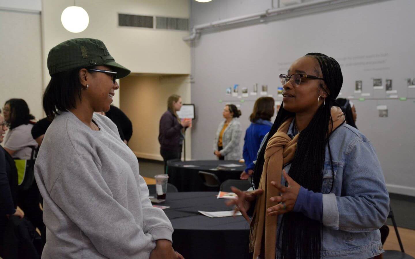 Two women having a discussion while attending the Roosevelt hosted 2025, Women on the Move: Standing by My Sister Conference